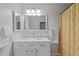 Bathroom featuring a dual sink vanity, ample lighting, and neutral wall colors at 2808 Newquay St, Durham, NC 27705