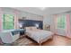 Bright bedroom featuring wood floors, a desk by the window, and a calming color scheme at 2808 Newquay St, Durham, NC 27705