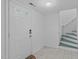 Entryway with white door, ceramic floors, and staircase at 2808 Newquay St, Durham, NC 27705