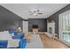 Modern living room with a painted brick fireplace, cozy blue sofa, and hardwood floors at 2808 Newquay St, Durham, NC 27705