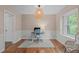 Bright office space featuring a modern desk, wood floors, and a stylish light fixture at 2808 Newquay St, Durham, NC 27705