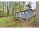 Storage shed in backyard with a walkway and white trim at 2808 Newquay St, Durham, NC 27705