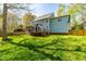 Backyard view of the house with a screened porch and deck overlooking the well-maintained lawn at 2868 Anfield Rd, Raleigh, NC 27606