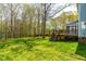 Lush backyard featuring a spacious deck and mature trees offers a serene outdoor retreat at 2868 Anfield Rd, Raleigh, NC 27606