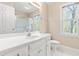 Well-lit bathroom features a single sink vanity, framed mirror, and shower with glass doors at 2868 Anfield Rd, Raleigh, NC 27606