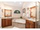 Luxury bathroom boasts double sinks, granite countertops, a jetted tub, and stylish fixtures at 2868 Anfield Rd, Raleigh, NC 27606