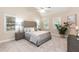 Bright bedroom with neutral colors, plush carpet, and a comfortable upholstered headboard at 2868 Anfield Rd, Raleigh, NC 27606
