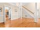 Open dining area with hardwood floors and staircase access at 2868 Anfield Rd, Raleigh, NC 27606