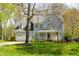 Charming two-story home with a manicured lawn, attached garage, and lovely front porch at 2868 Anfield Rd, Raleigh, NC 27606