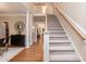 Bright foyer with hardwood floors, staircase, and view to dining room at 2868 Anfield Rd, Raleigh, NC 27606