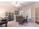 Bright game room offers four chairs, shelving, natural light and neutral colors for relaxation and enjoyment at 2868 Anfield Rd, Raleigh, NC 27606