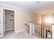 Well lit hallway with neutral paint and carpeted floor at 2868 Anfield Rd, Raleigh, NC 27606
