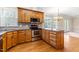 Lovely kitchen features wood cabinets, stainless appliances, granite countertops, and hardwood floors at 2868 Anfield Rd, Raleigh, NC 27606