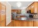 Well-equipped kitchen with stainless steel appliances, wooden cabinetry and granite countertops at 2868 Anfield Rd, Raleigh, NC 27606