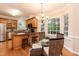 Eat-in kitchen with wood cabinets, stainless appliances, and sunny breakfast nook at 2868 Anfield Rd, Raleigh, NC 27606