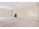 Spacious living room with neutral carpeting, bright windows, and a cozy fireplace at 2868 Anfield Rd, Raleigh, NC 27606