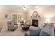 This bright living room boasts french doors, neutral decor, and comfortable seating arrangements at 2868 Anfield Rd, Raleigh, NC 27606