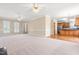 Spacious living room with neutral carpeting, bright windows, and modern ceiling fans at 2868 Anfield Rd, Raleigh, NC 27606
