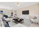 Spacious, staged living room with neutral carpeting, bright windows, and a cozy fireplace at 2868 Anfield Rd, Raleigh, NC 27606