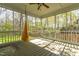 Relaxing screened porch with comfortable seating, a ceiling fan, and scenic outdoor vistas at 2868 Anfield Rd, Raleigh, NC 27606