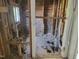 Bathroom showing exposed framing and plumbing awaiting restoration, offering a blank canvas at 307 Watson St, Creedmoor, NC 27522