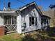 Side view of the home featuring white siding, classic shutters, and a screened-in porch at 307 Watson St, Creedmoor, NC 27522