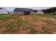 Rear exterior view featuring a screen porch and expansive yard at 32 Tanseyleaf Dr, Smithfield, NC 27577