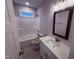 Bright bathroom with a shower-tub, white vanity, and modern fixtures at 32 Tanseyleaf Dr, Smithfield, NC 27577