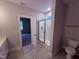 Elegant bathroom with a walk-in shower, modern fixtures, and tile flooring at 32 Tanseyleaf Dr, Smithfield, NC 27577