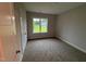 Cozy bedroom with plush carpet and a window offering scenic views at 32 Tanseyleaf Dr, Smithfield, NC 27577