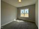 Cozy bedroom with plush carpet, a white window frame, and natural light at 32 Tanseyleaf Dr, Smithfield, NC 27577