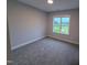 Inviting bedroom with soft carpet and a large window to maximize natural light at 32 Tanseyleaf Dr, Smithfield, NC 27577