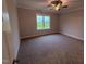 Cozy bedroom with plush carpeting and a large window offering natural light at 32 Tanseyleaf Dr, Smithfield, NC 27577