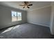 Spacious bedroom with a ceiling fan, plush carpet, natural light, and neutral paint at 32 Tanseyleaf Dr, Smithfield, NC 27577