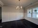 Bright dining room with modern lighting, hardwood floors, and wainscoting at 32 Tanseyleaf Dr, Smithfield, NC 27577