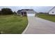 Charming single-Gathering home with a well-manicured lawn and a concrete driveway at 32 Tanseyleaf Dr, Smithfield, NC 27577