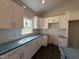 Kitchen featuring white cabinets, subway tile backsplash, stainless steel appliances, and hardwood floors at 32 Tanseyleaf Dr, Smithfield, NC 27577
