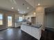 New kitchen featuring white cabinets, an island, modern pendant lights, and stainless steel appliances at 32 Tanseyleaf Dr, Smithfield, NC 27577