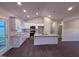 Modern kitchen featuring granite countertops, white cabinets, and stainless steel appliances at 32 Tanseyleaf Dr, Smithfield, NC 27577