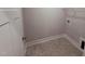 Practical laundry room with tile flooring, shelving, and ample space for appliances at 32 Tanseyleaf Dr, Smithfield, NC 27577