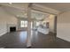 Open-concept living room and kitchen with a fireplace, large windows, and hardwood floors at 32 Tanseyleaf Dr, Smithfield, NC 27577