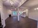 Open-concept living area featuring wood floors, a fireplace, and views into the modern kitchen at 32 Tanseyleaf Dr, Smithfield, NC 27577