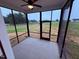 Screened patio with a ceiling fan and views of the landscaped backyard at 32 Tanseyleaf Dr, Smithfield, NC 27577