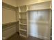 Spacious walk-in closet with custom shelving and wooden rods for ample storage at 32 Tanseyleaf Dr, Smithfield, NC 27577