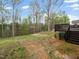 View of backyard featuring trees, lawn, and a wooden deck with steps at 329 Chamberlain Dr, Clayton, NC 27527