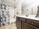 Bathroom with dark cabinets, a shower-tub combo, and a unique shower curtain at 329 Chamberlain Dr, Clayton, NC 27527