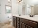 Well-lit bathroom with double vanity, dark wood cabinets, and tiled floors at 329 Chamberlain Dr, Clayton, NC 27527