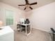 Bright bedroom with neutral carpet and a large window, currently staged as office at 329 Chamberlain Dr, Clayton, NC 27527
