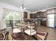 Bright eat-in kitchen features modern appliances, granite counters, and opens to outdoor deck at 329 Chamberlain Dr, Clayton, NC 27527