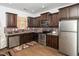 Kitchen with stainless steel appliances, granite countertops, dark wood cabinets, and decorative backsplash at 329 Chamberlain Dr, Clayton, NC 27527